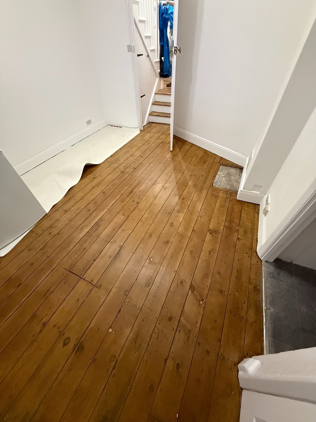 Restored wooden hallway floor in Worthing Sussex, sanded and sealed timber boards
