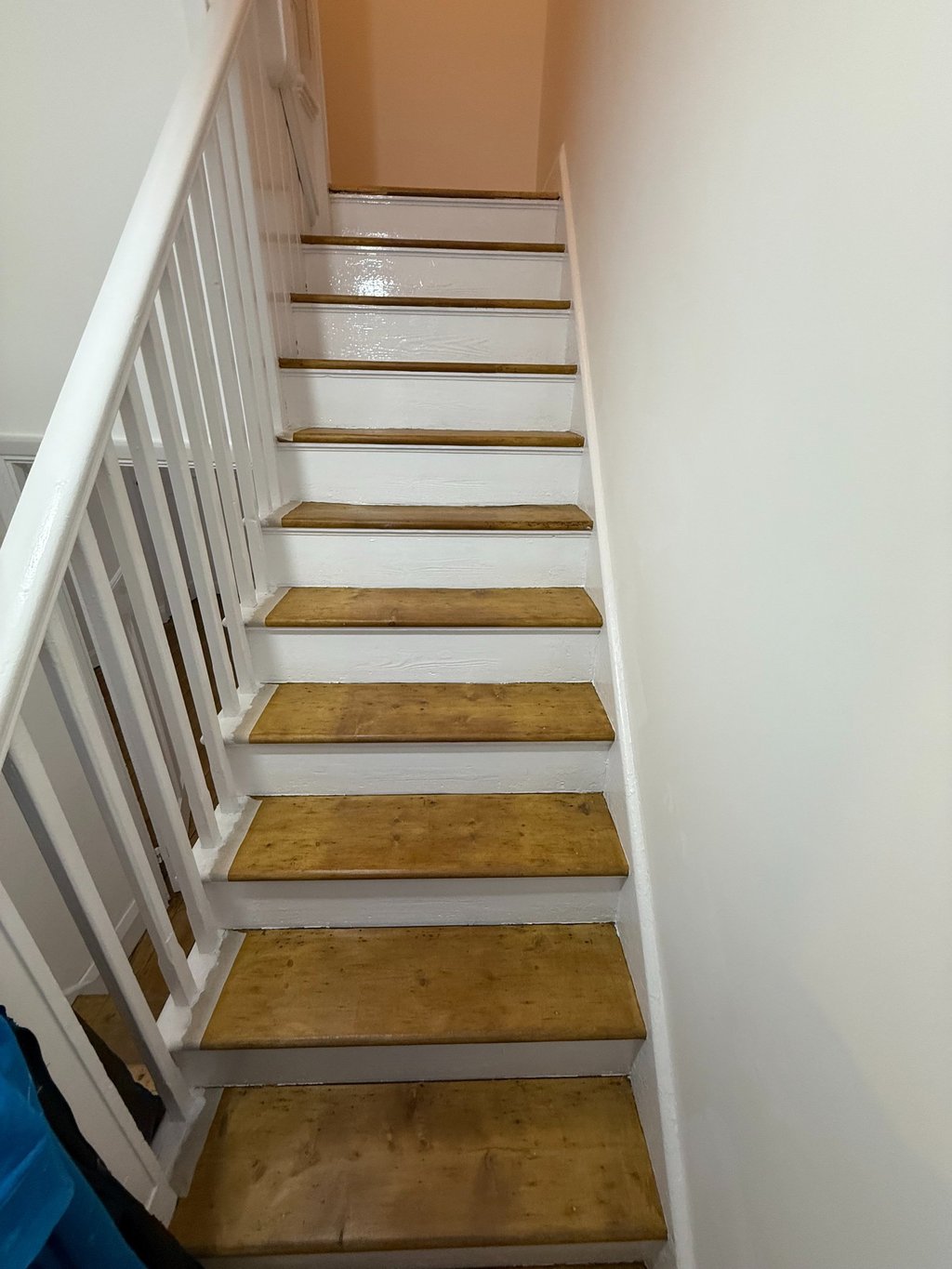 Indoor wooden staircase with light oak steps and white banister spindles in Brighton. 