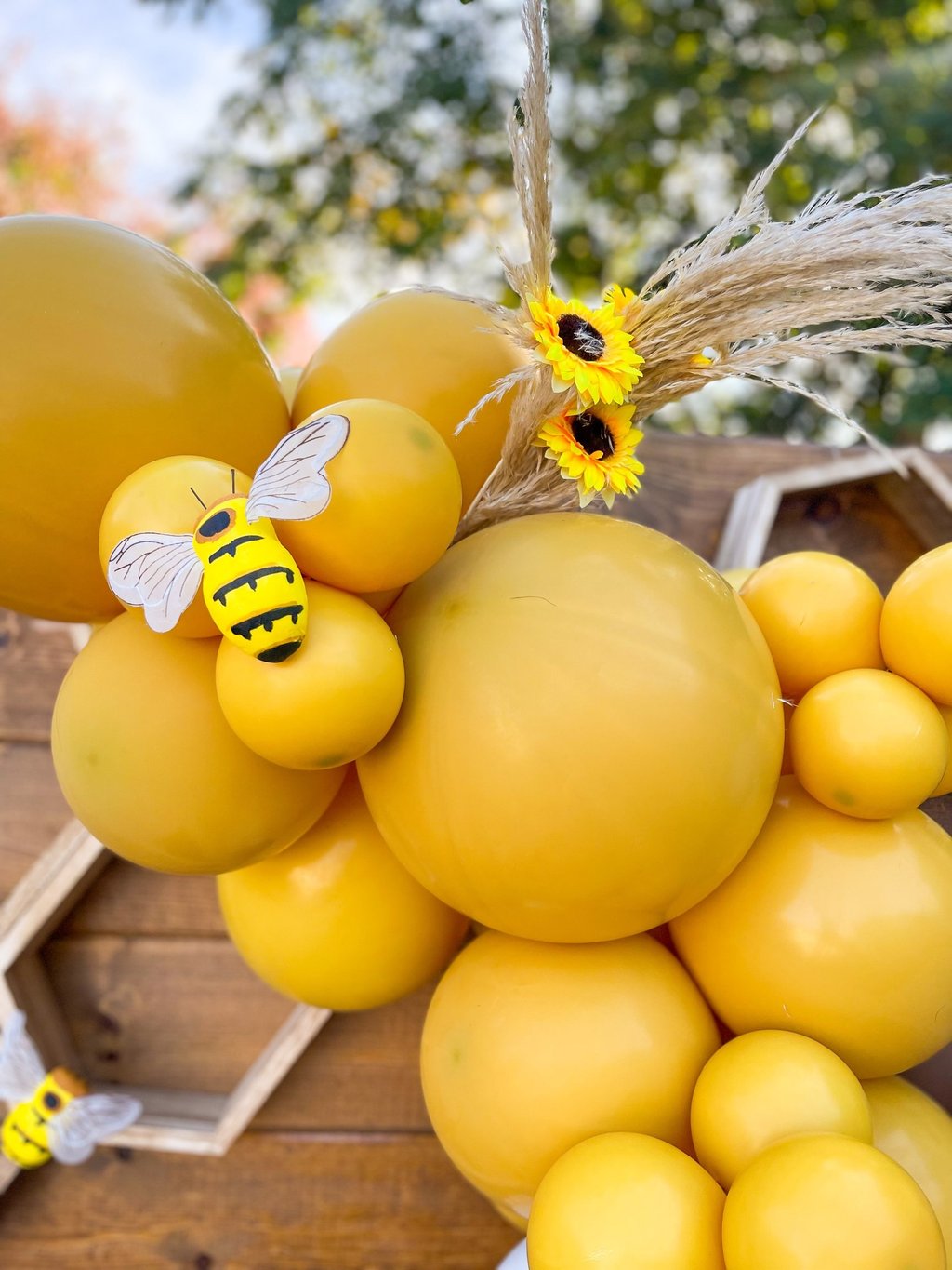 a bunch of balloons and balloons with bees photo backdrop event designer