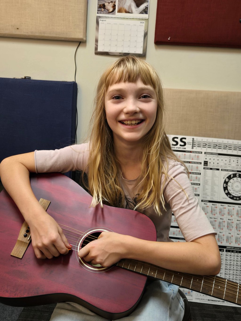Girl learning to play guitar