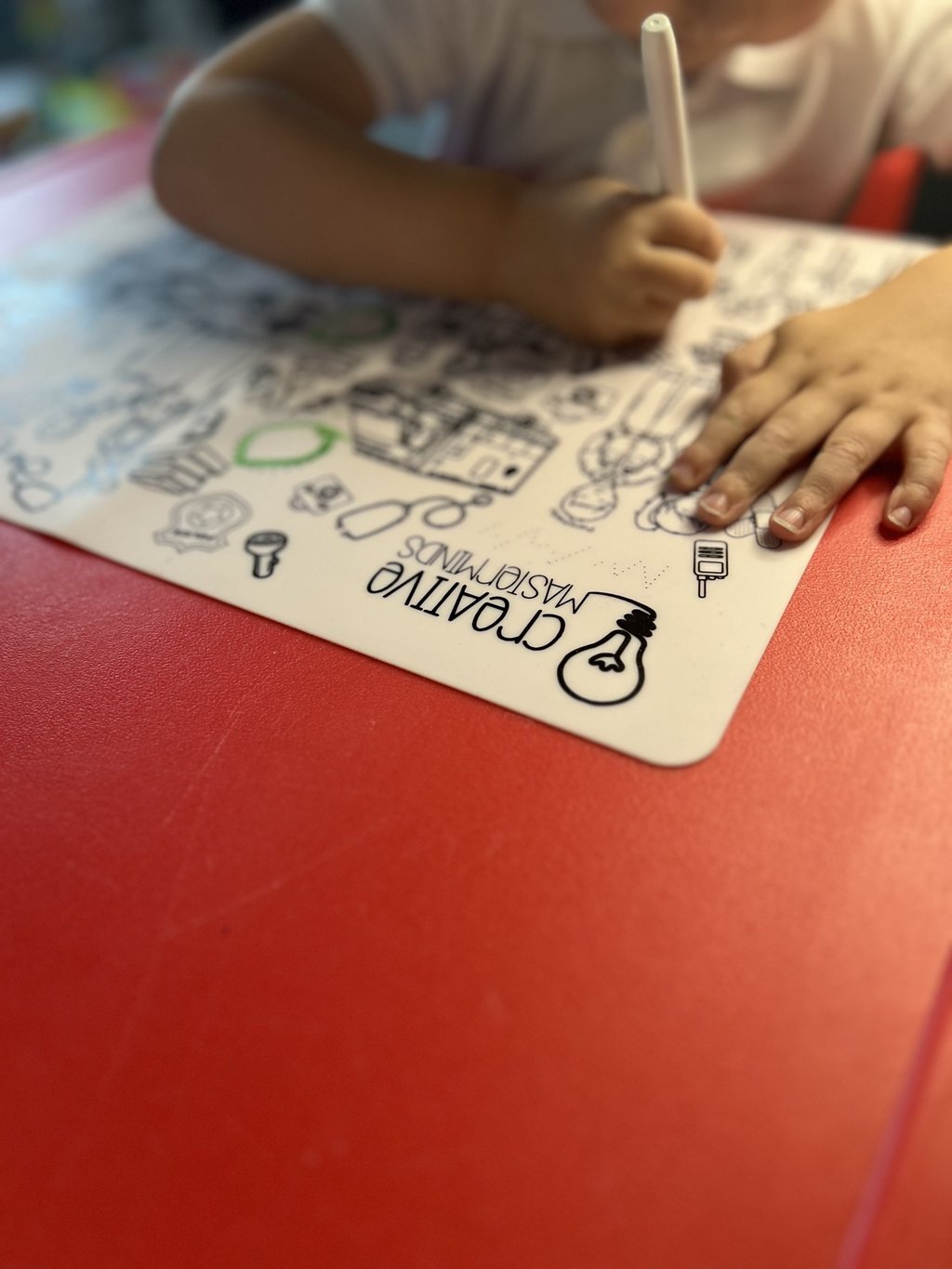 Toddler using Scribbly Kids reusable drawing mat at home for mess-free drawing and learning