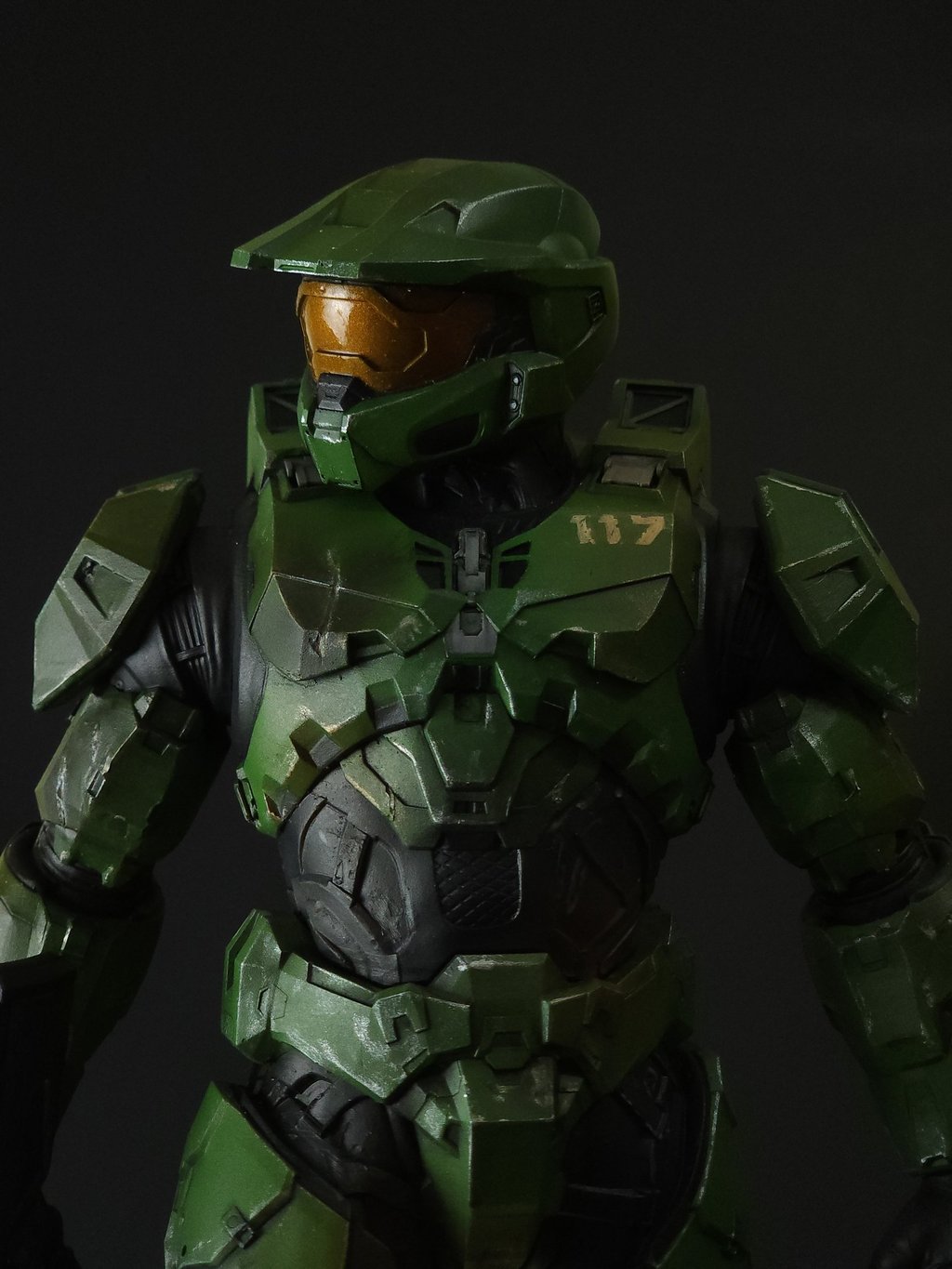 Close-up of Master Chief Spartan 117 green MJOLNIR armor 3D Print against a black background.