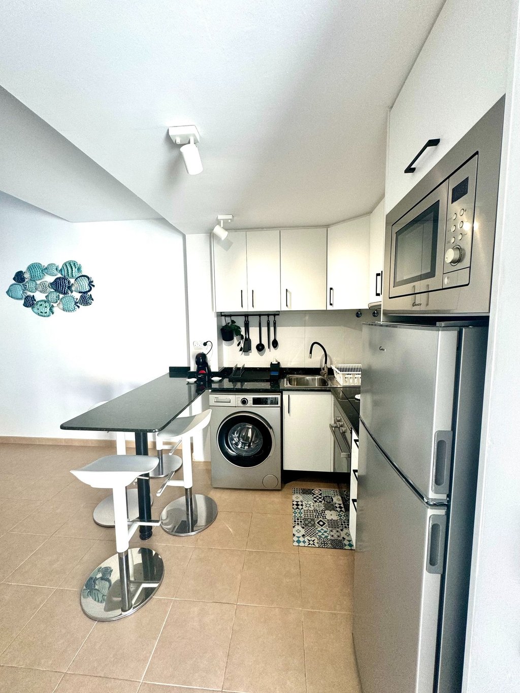 a kitchen with a washing machine and a washing machine