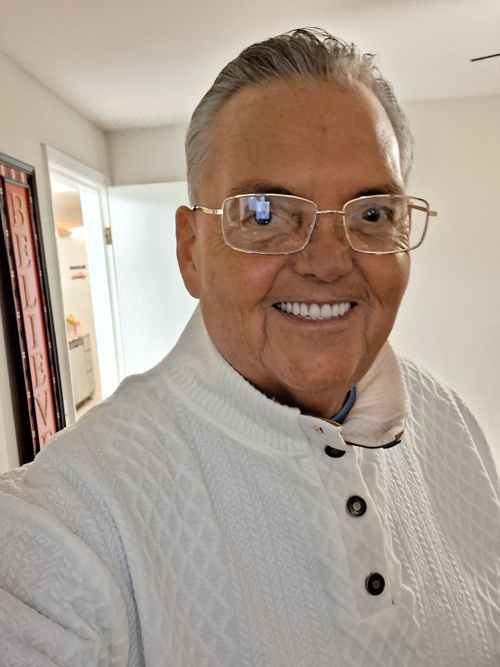 a man in a white shirt and glasses