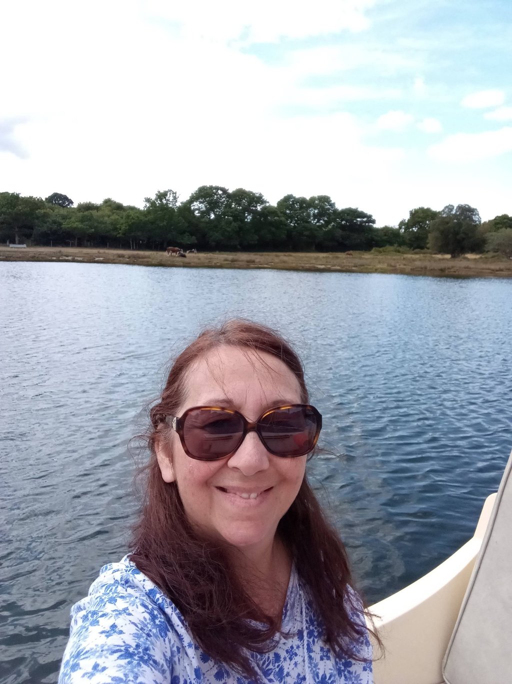 Artist in her boat on the river Beaulie, UK