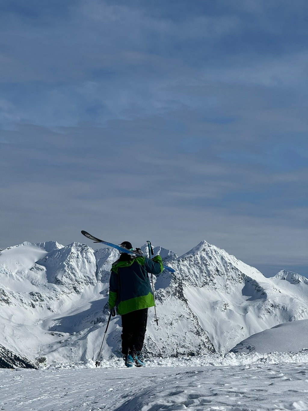 a person standing on a snowy mountain top