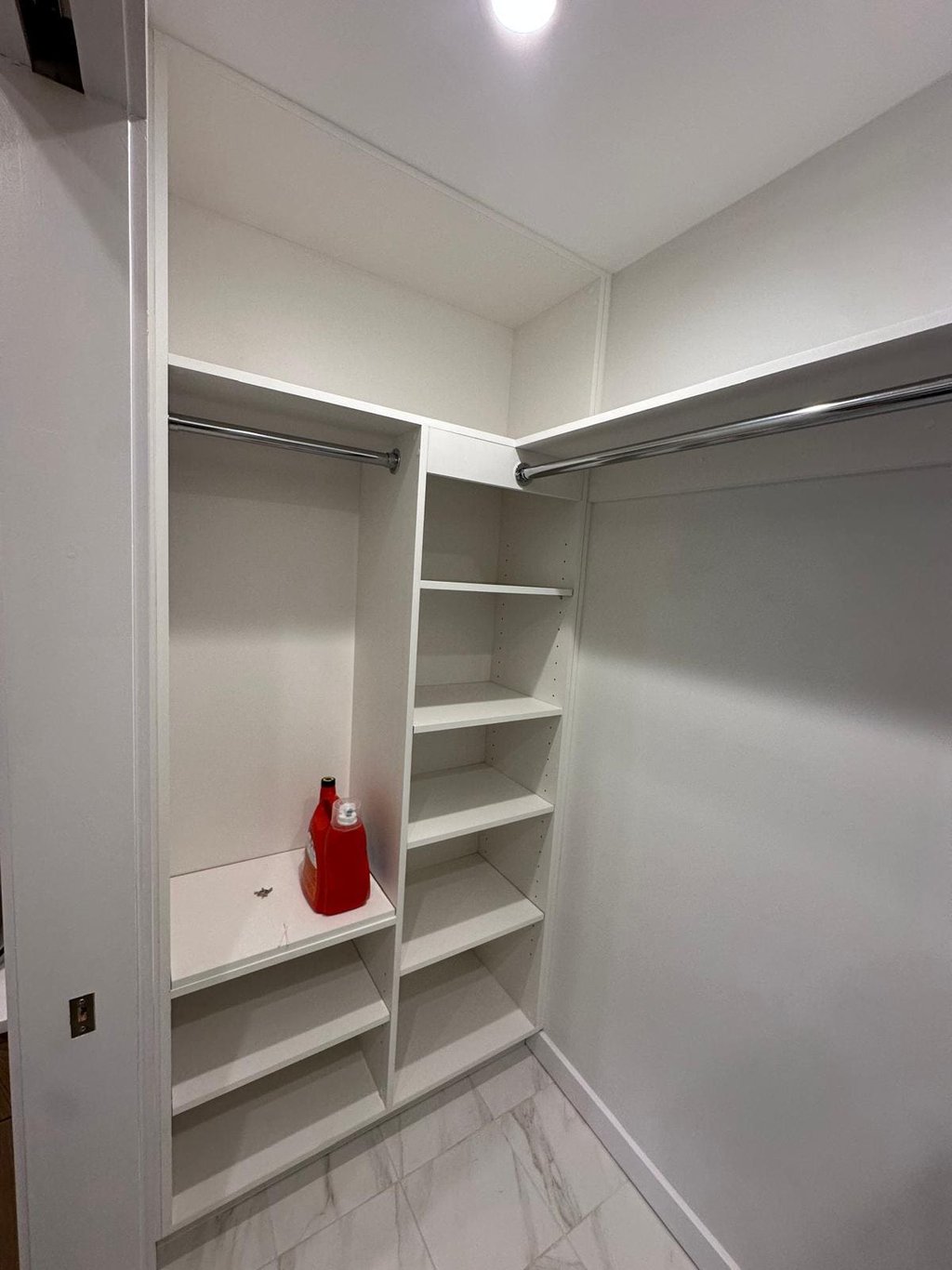 a white closet with shelves and shelves with a red fire hydrant