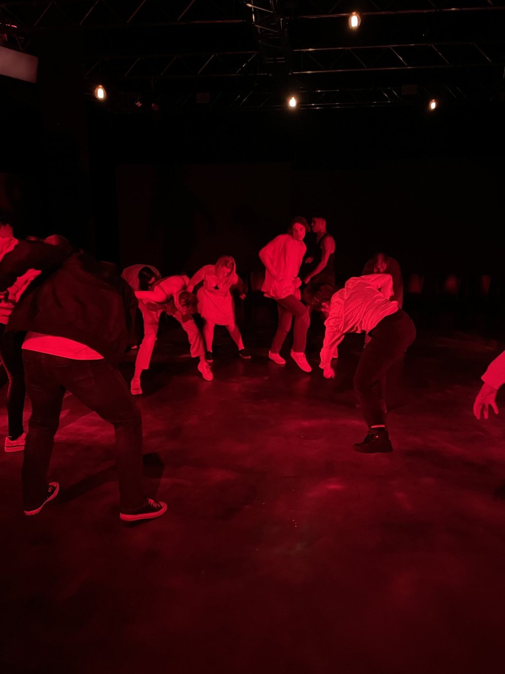 a group of people dancing in a dark room