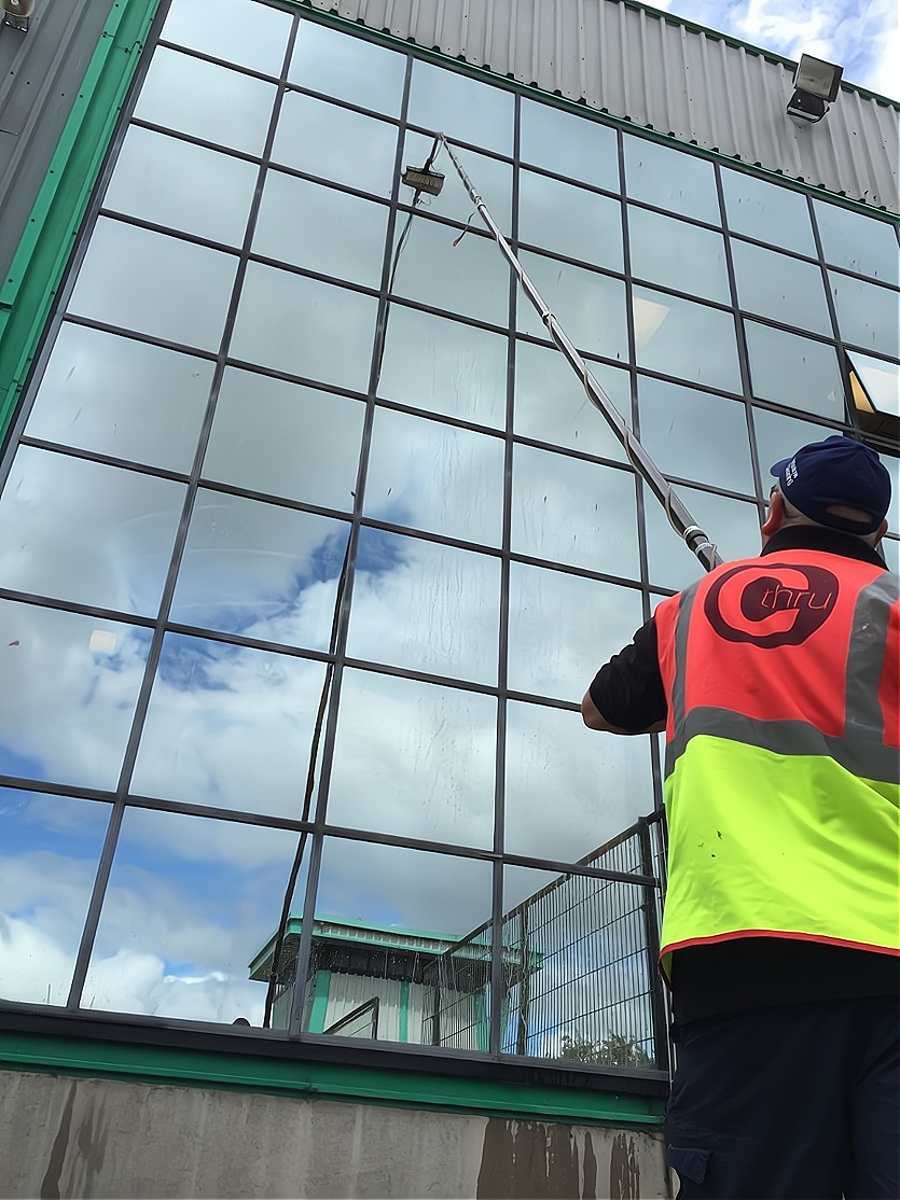 Window Cleaning long rech pole bieng used on commercial building in Exeter by C Thru Window Cleaners, Exeter.