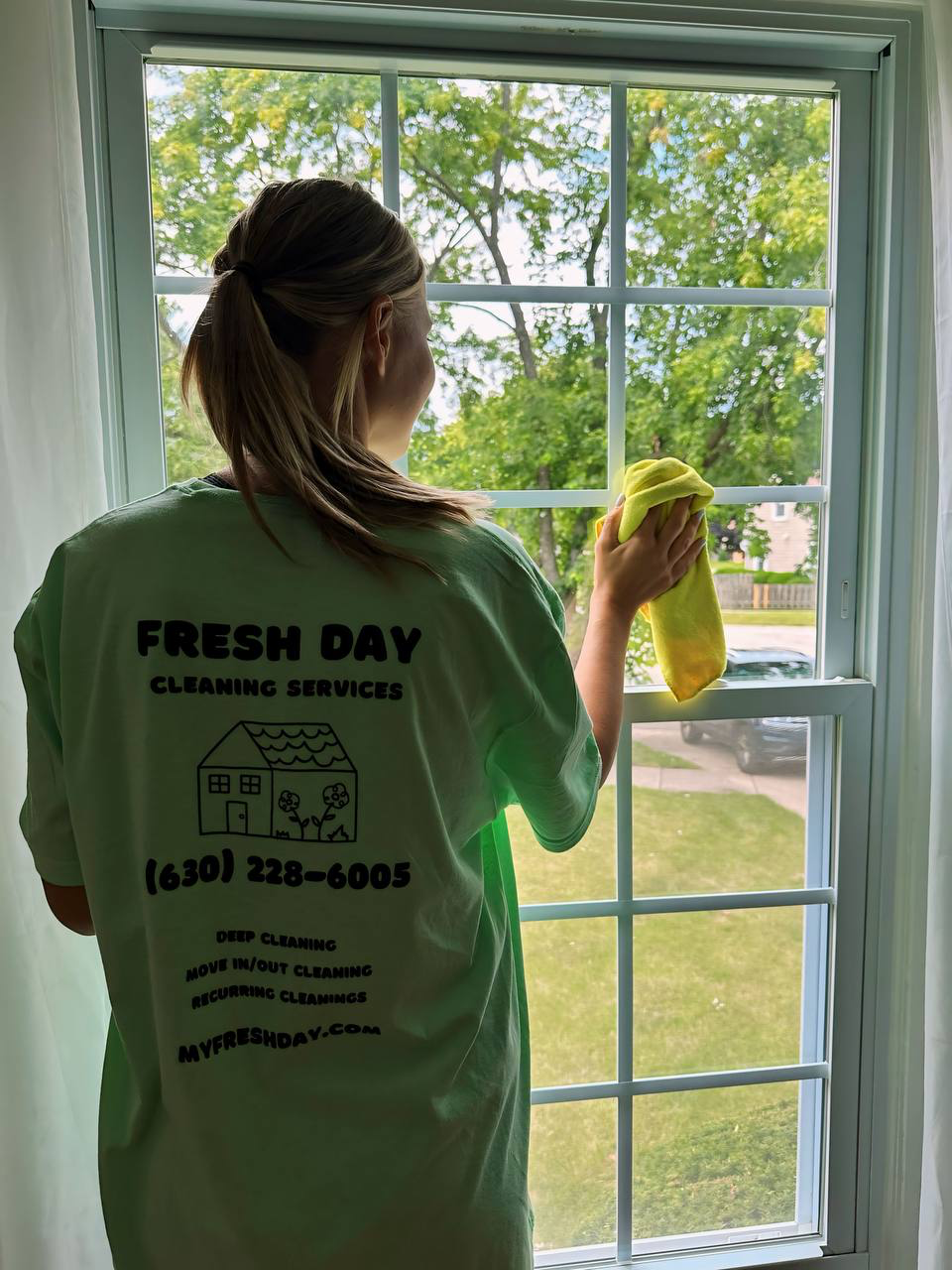 a woman cleaning a window