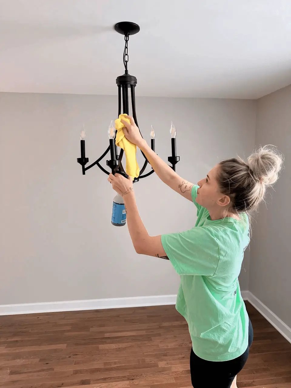 A professional cleaner carefully cleans a chandelier