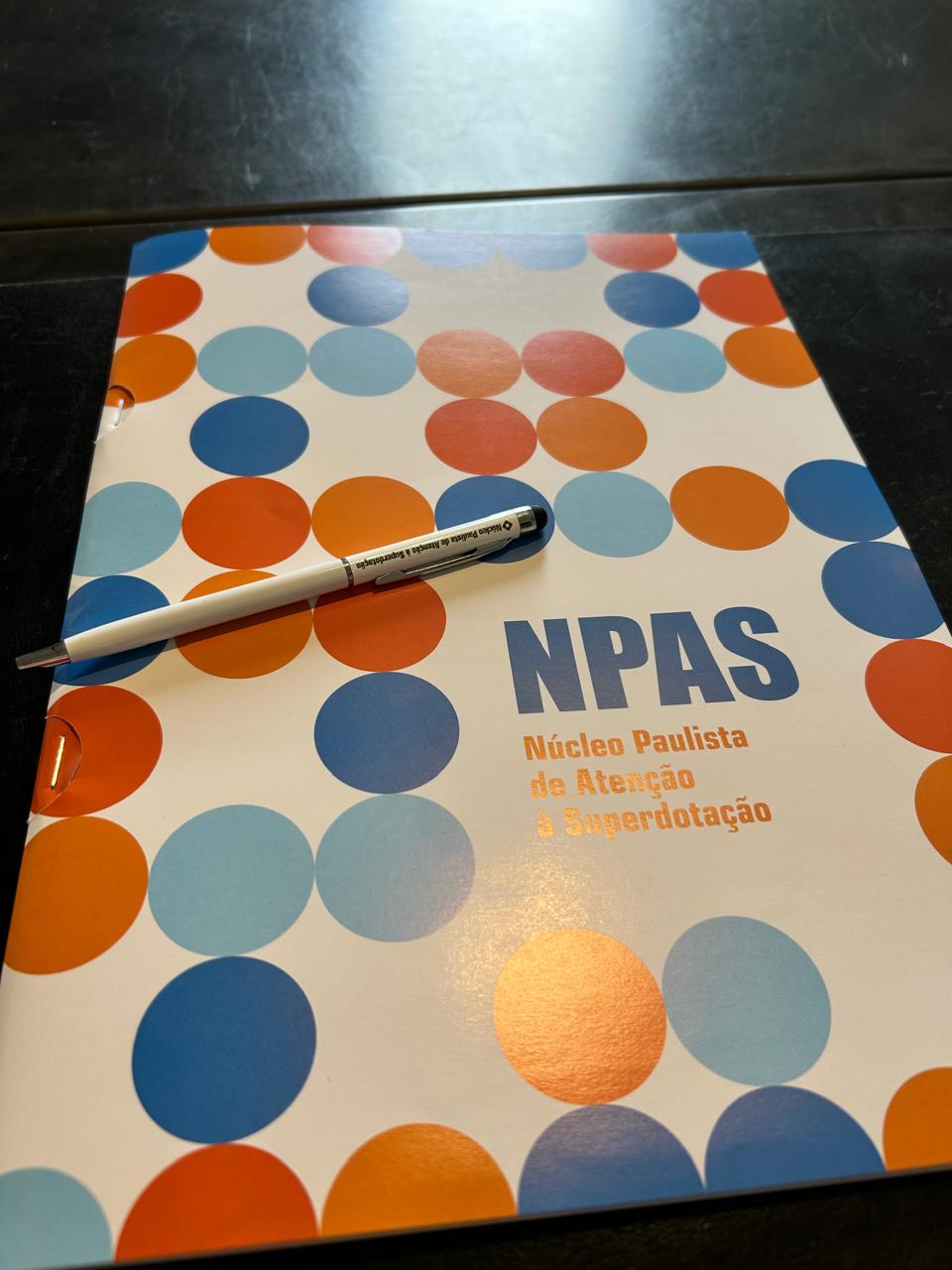 a pen and pen on a notebook with a pen