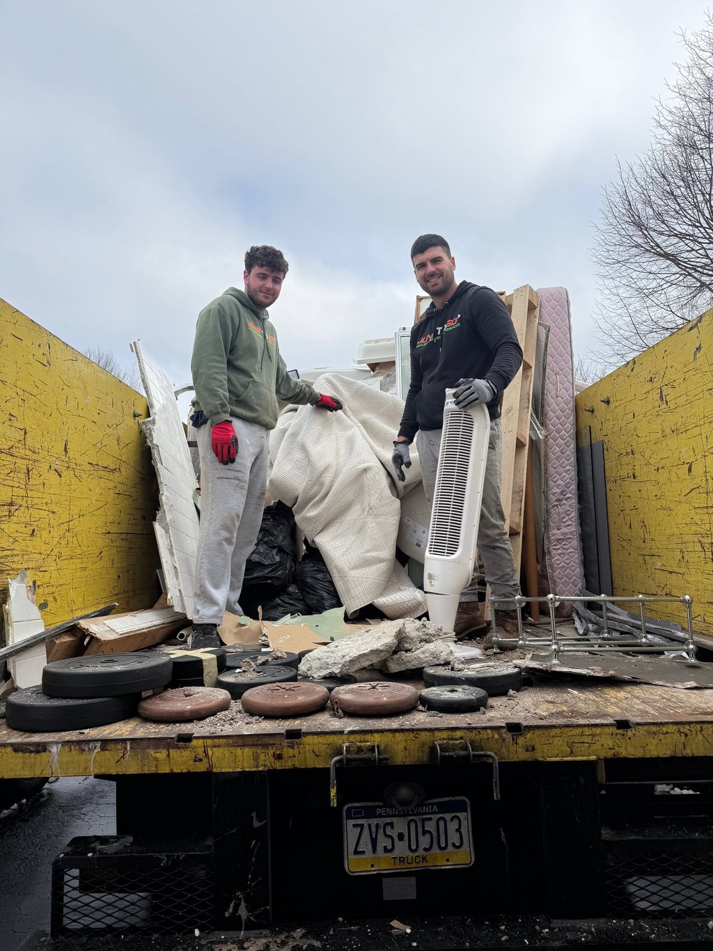 Alt Text: Junk removal crew loading a truck in Montgomery County.
