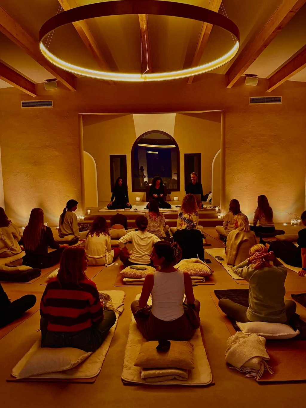 Candlelit meditation session in circular wellness temple