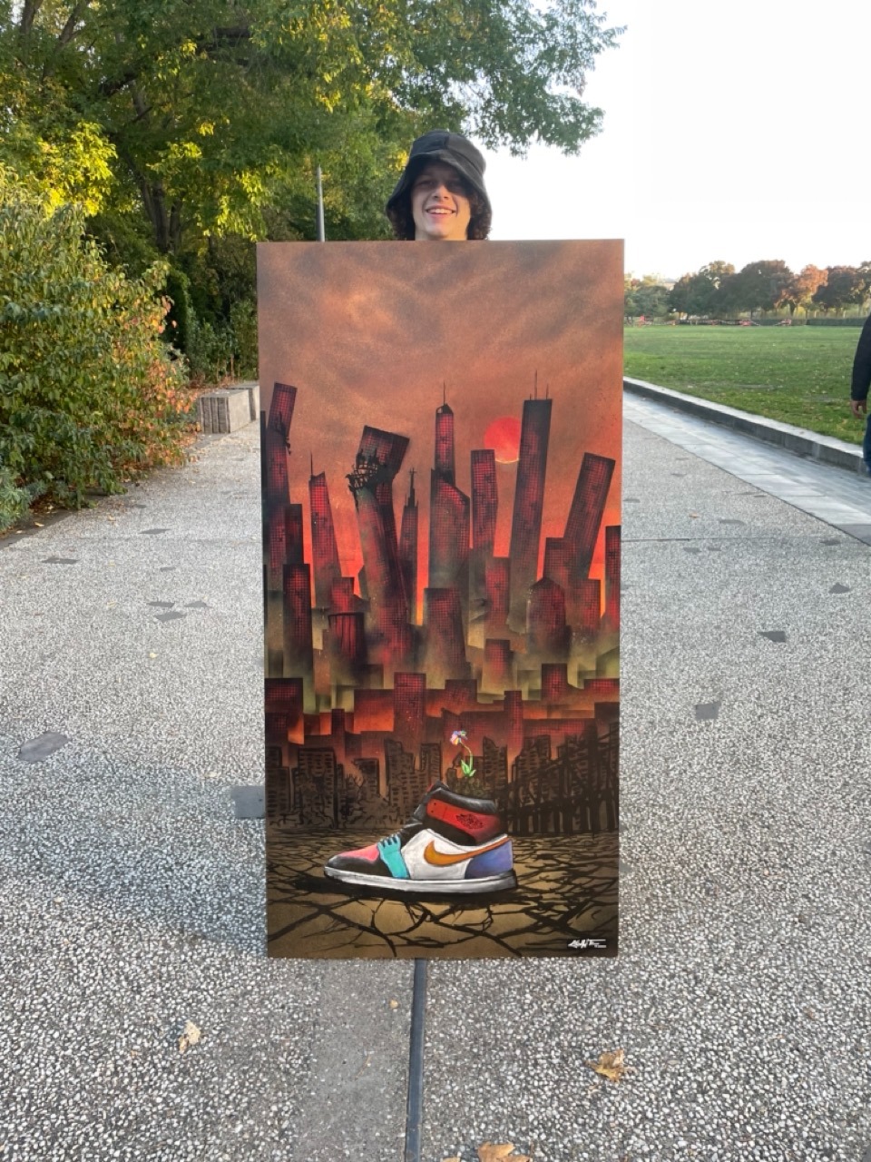 une peinture sombre avec une chaussure nike et une ville post apocalyptique 