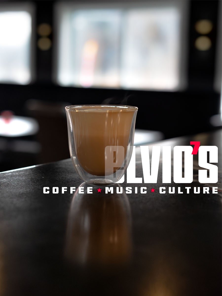 product image of a latte in a clear glass with Elvio's Coffee text in the image