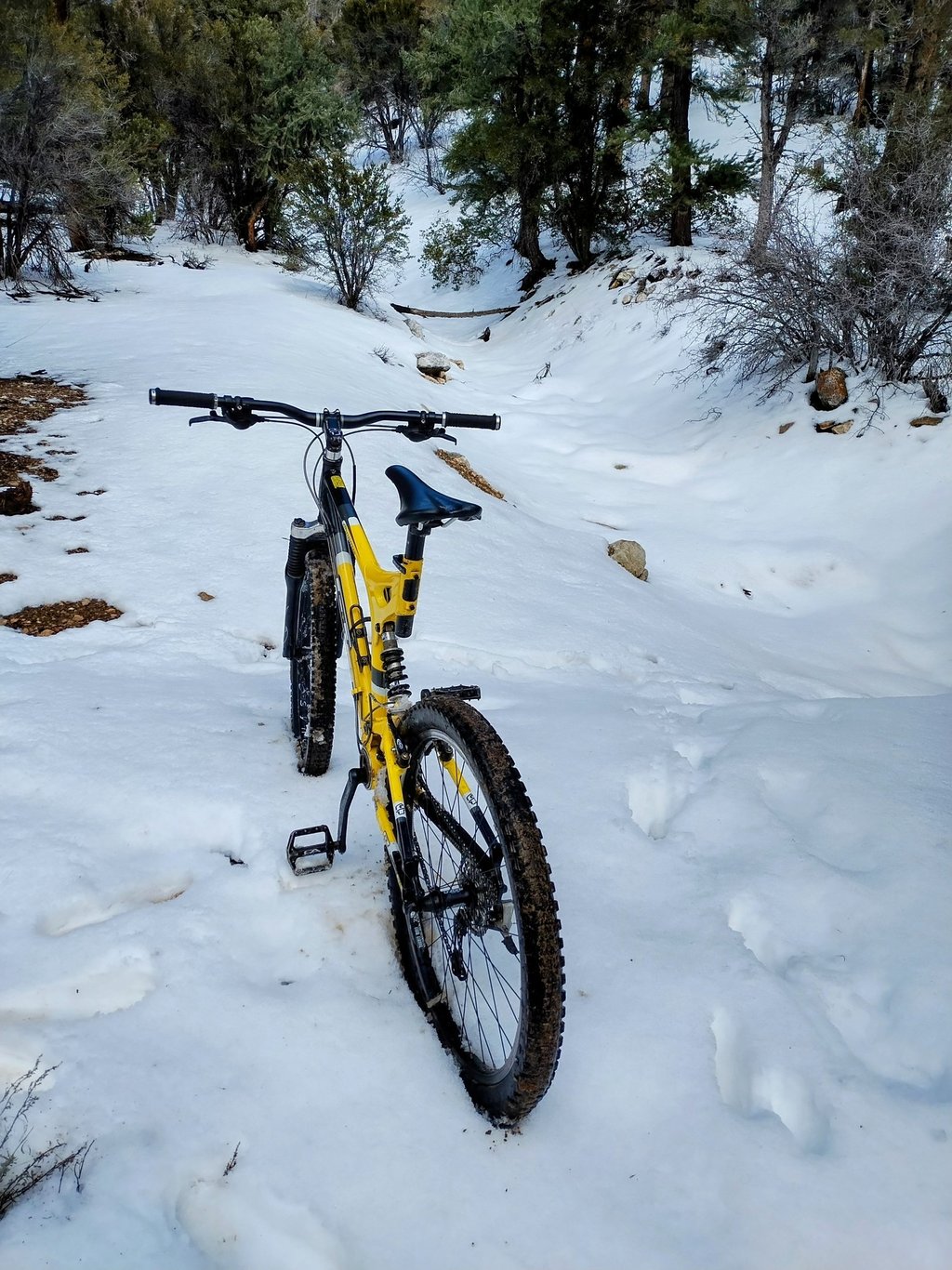 Mountain bike parked in deep snow on a winter trail in the San Bernardino mountains