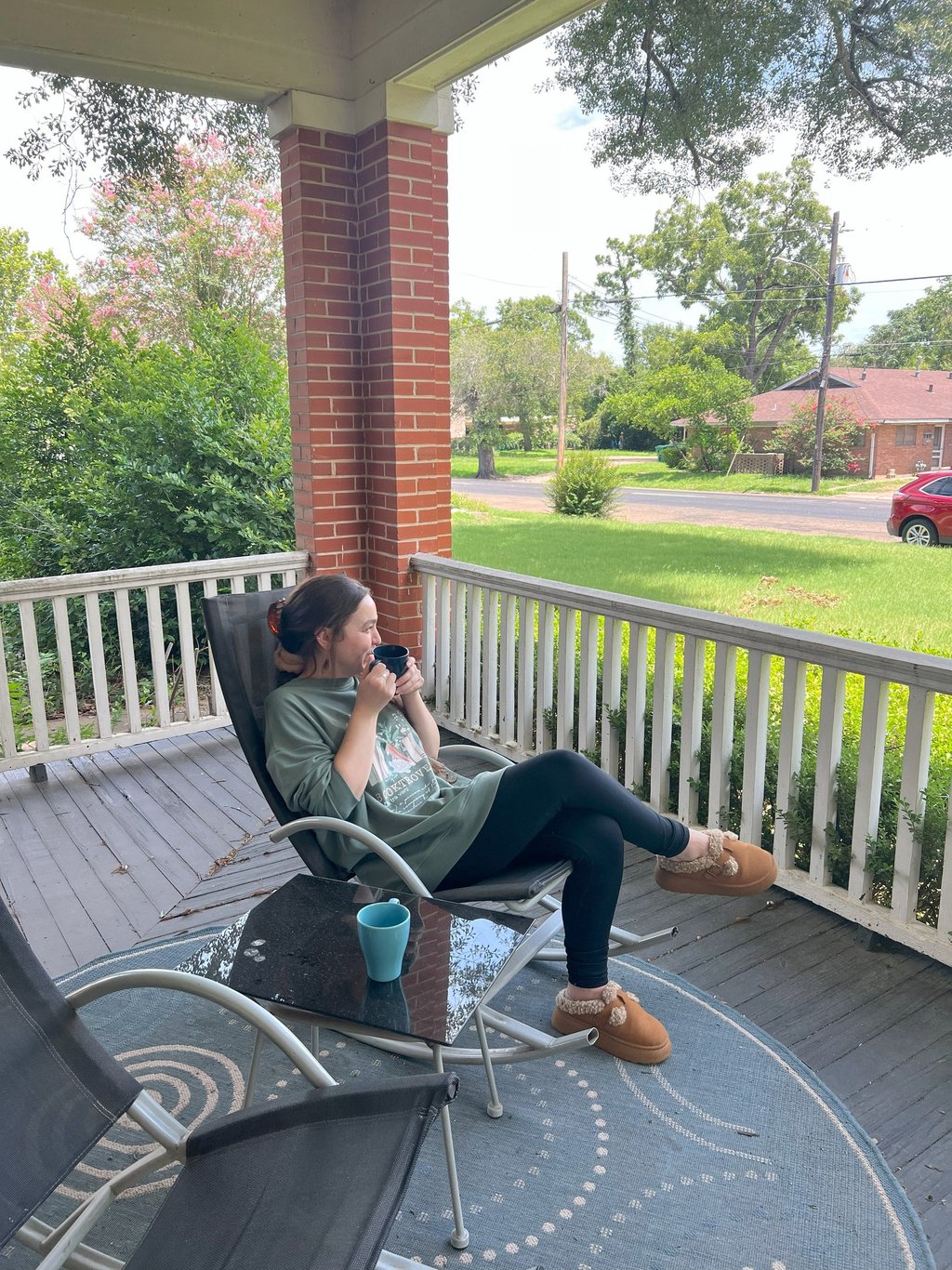 Woman sitting drinking coffee at Main Street House