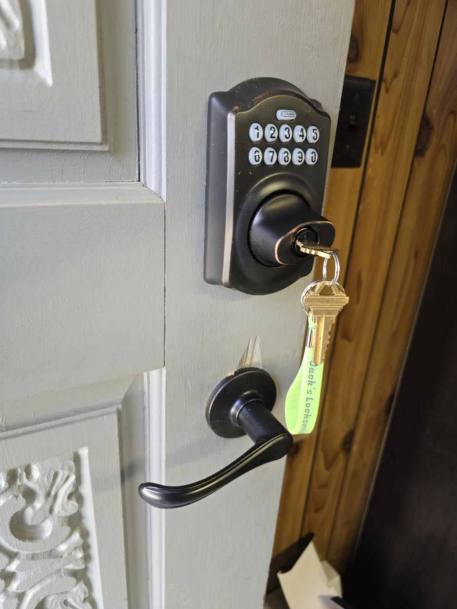 Residential door with keypad deadbolt and lever handle, installed for keyless entry