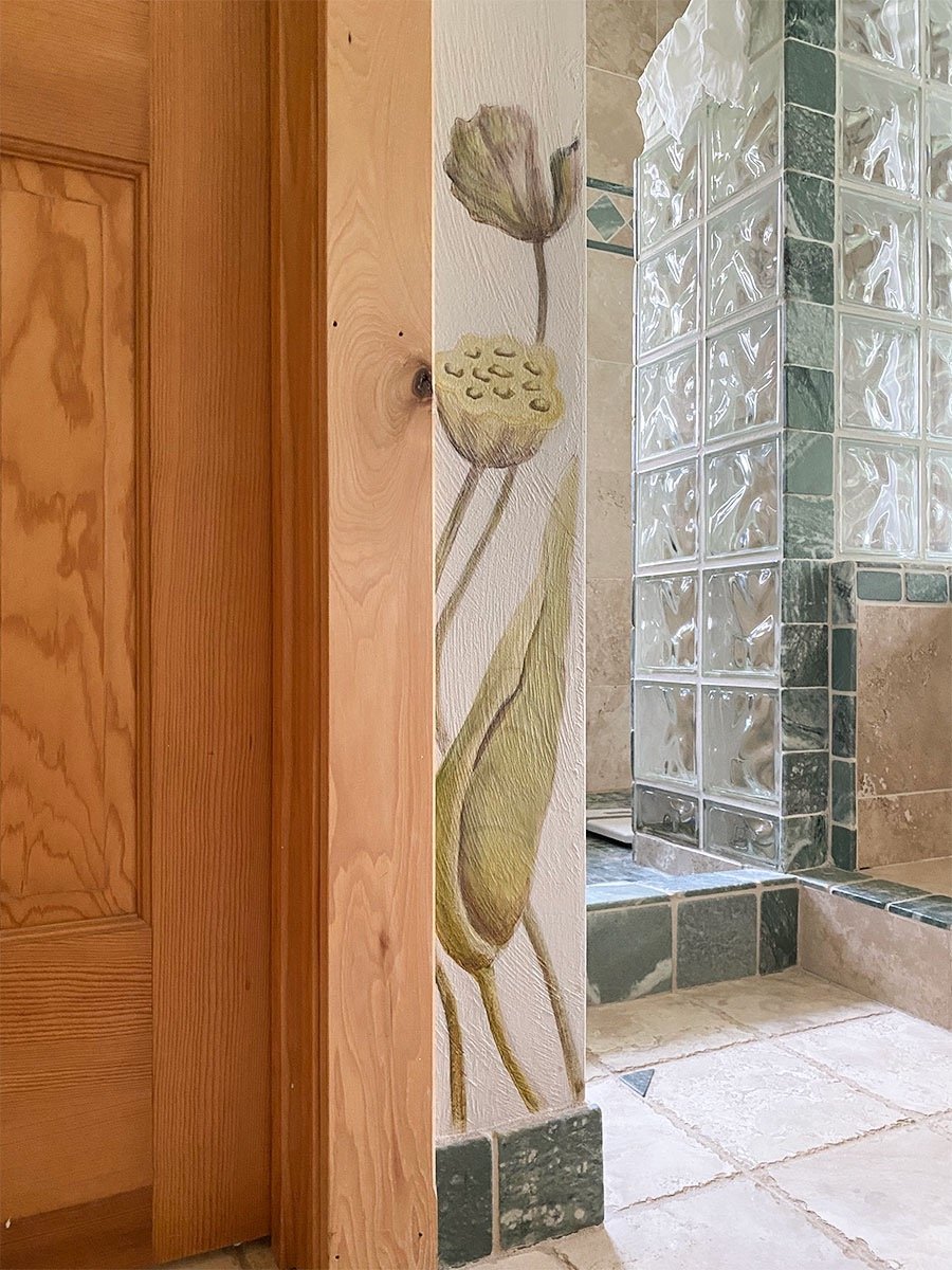 Detail of spa bath mural with 2 painted lotus seed pods on corner wall.
