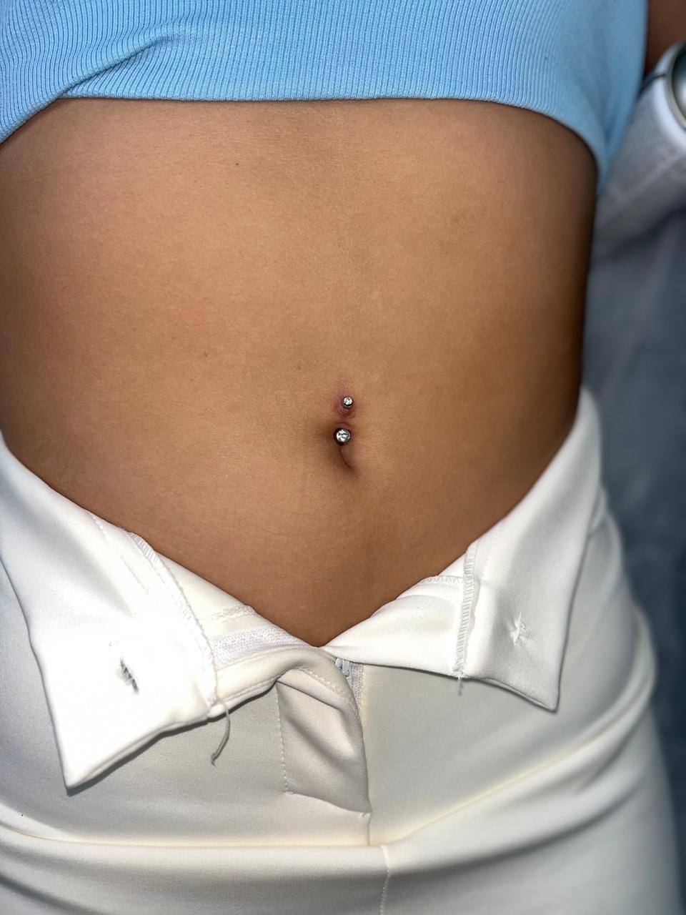 a woman with a piercing on her stomach