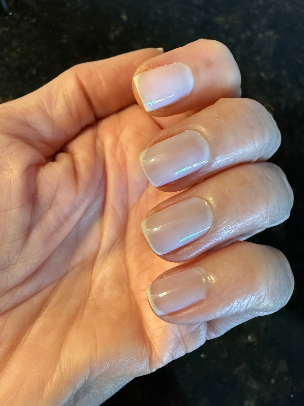 One coat of sheer nail polish giving a clean, natural, healthy looking finish on the nails.
