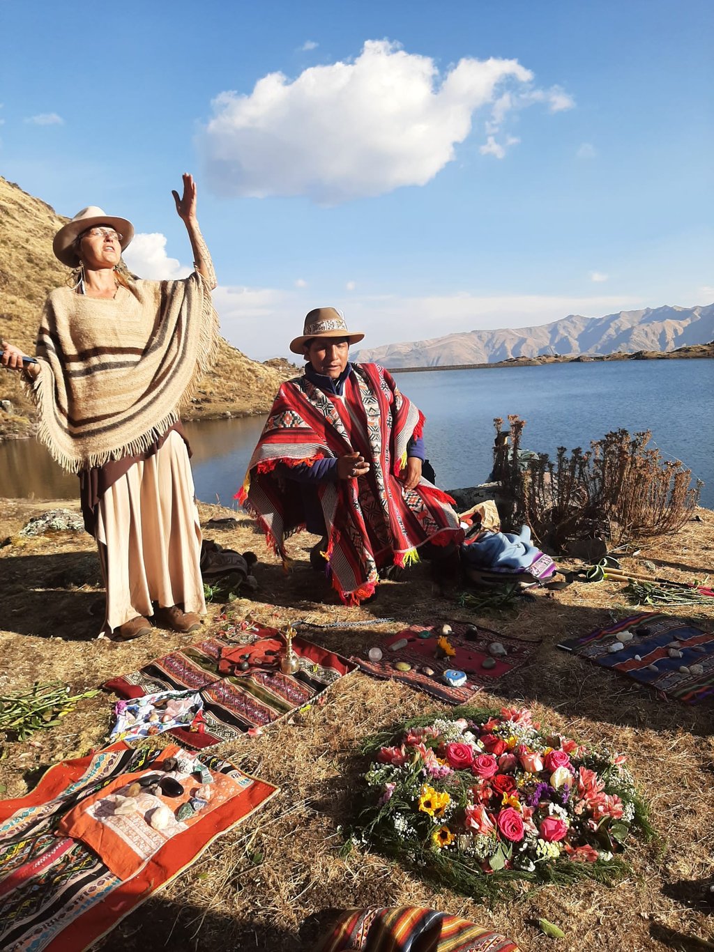 a medicine woman and a medicine man in a Despacho ceremony praying with the spirits of the mountain