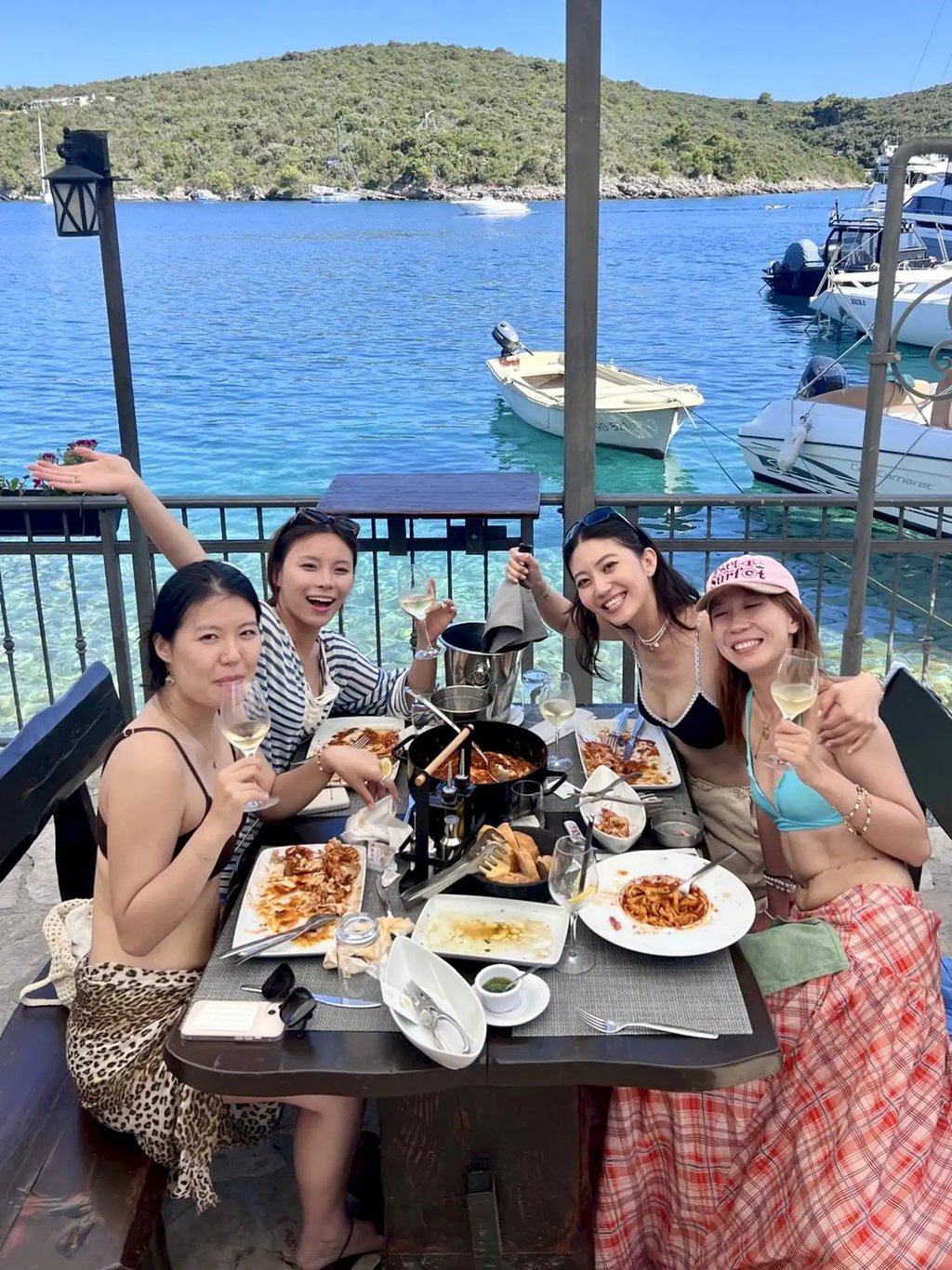 Girls enjoying seaside lunch in Sesula restaurant on Solta island during private boat trip from Split