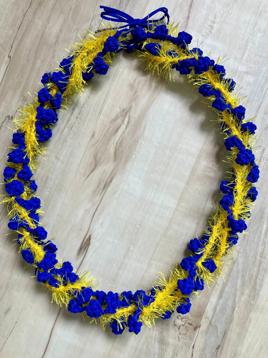 Royal blue and yellow twisted lei with bow at top
