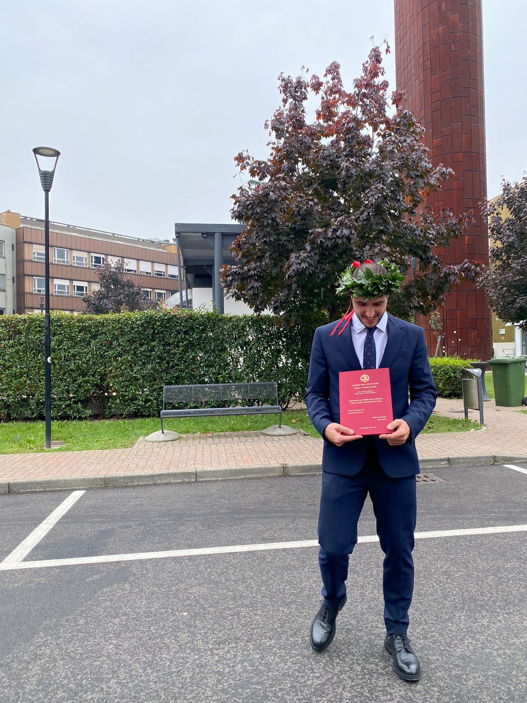 a man in a suit and tie is holding a certificate