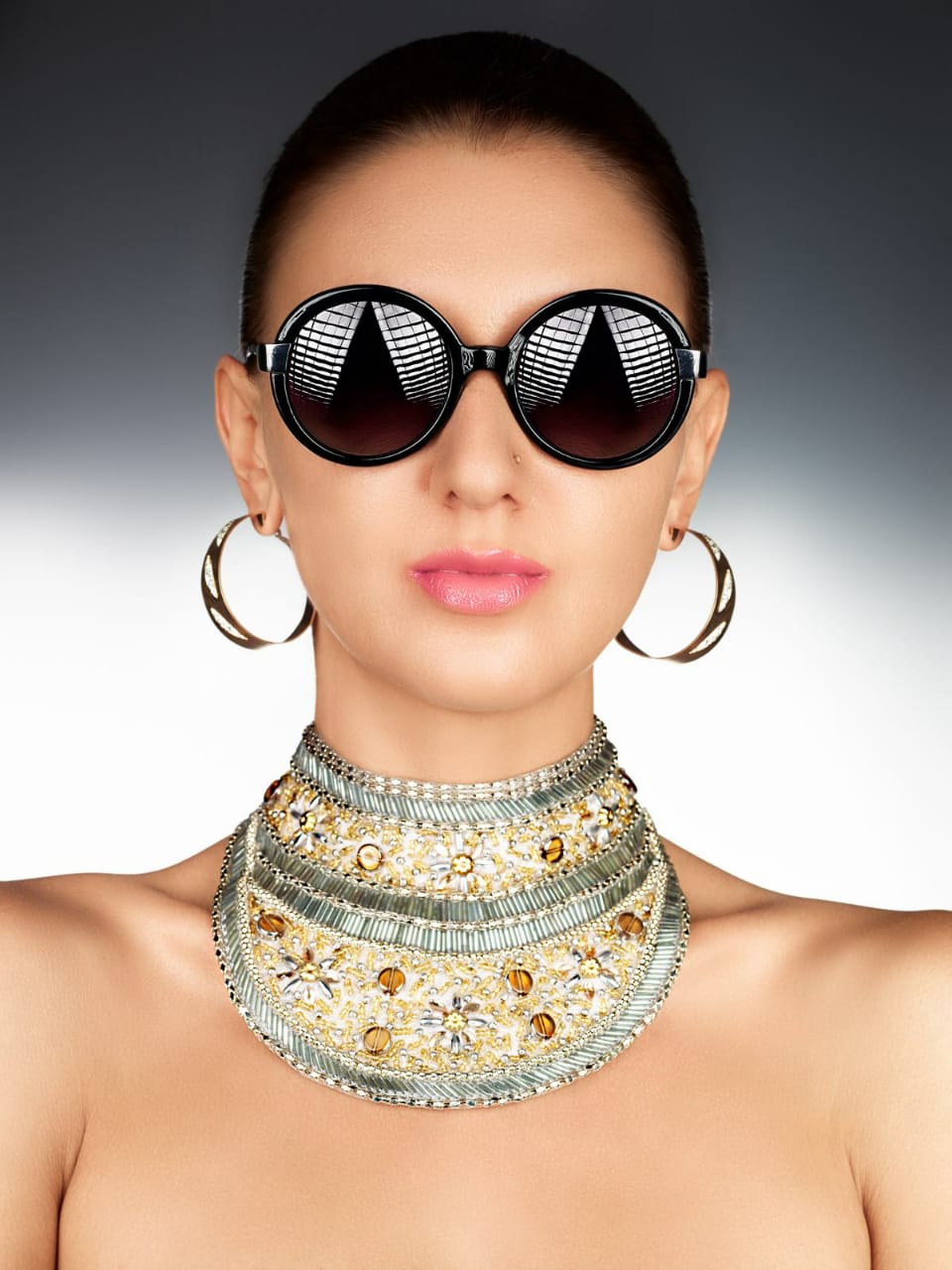 a woman wearing a choker and sunglasses