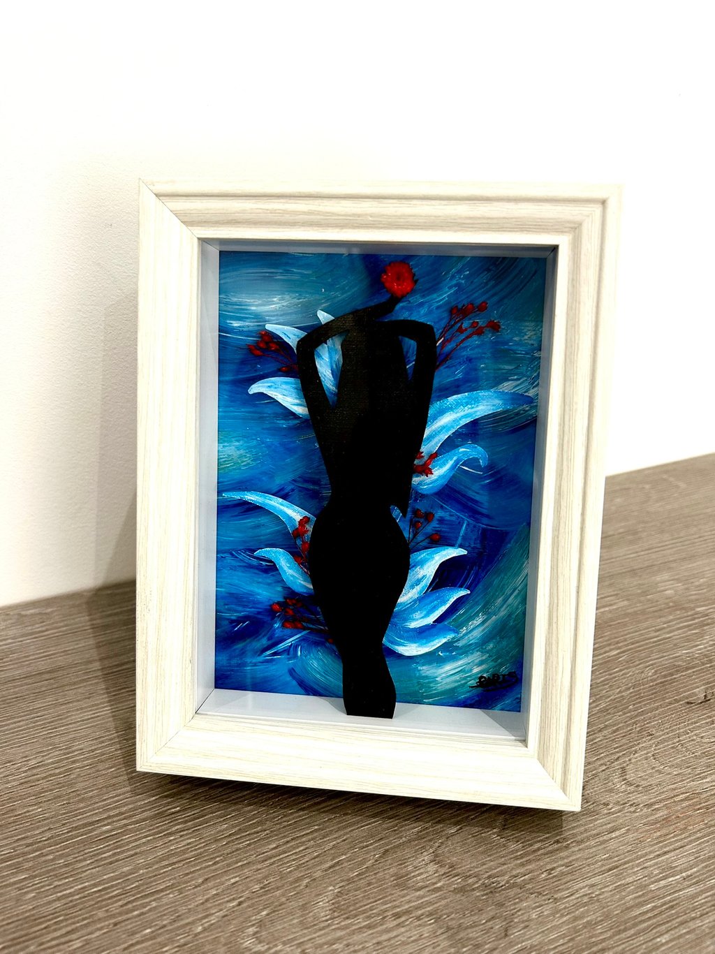 a painting of a woman in black and a red flower