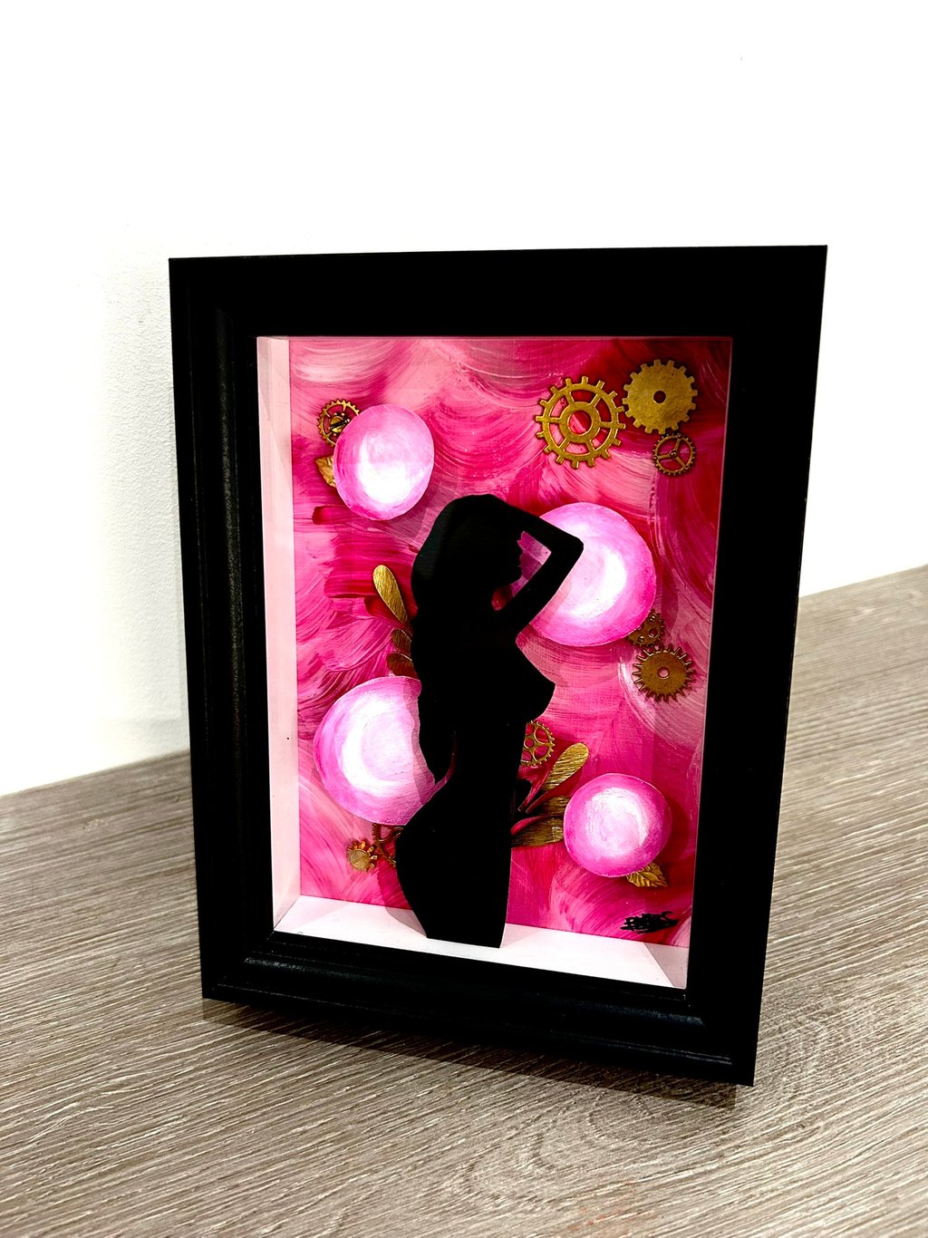 a picture of a woman silhouetted against a pink flower