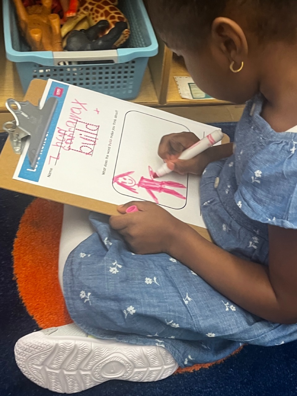 PreK students reflects on an OOPA worksheet.