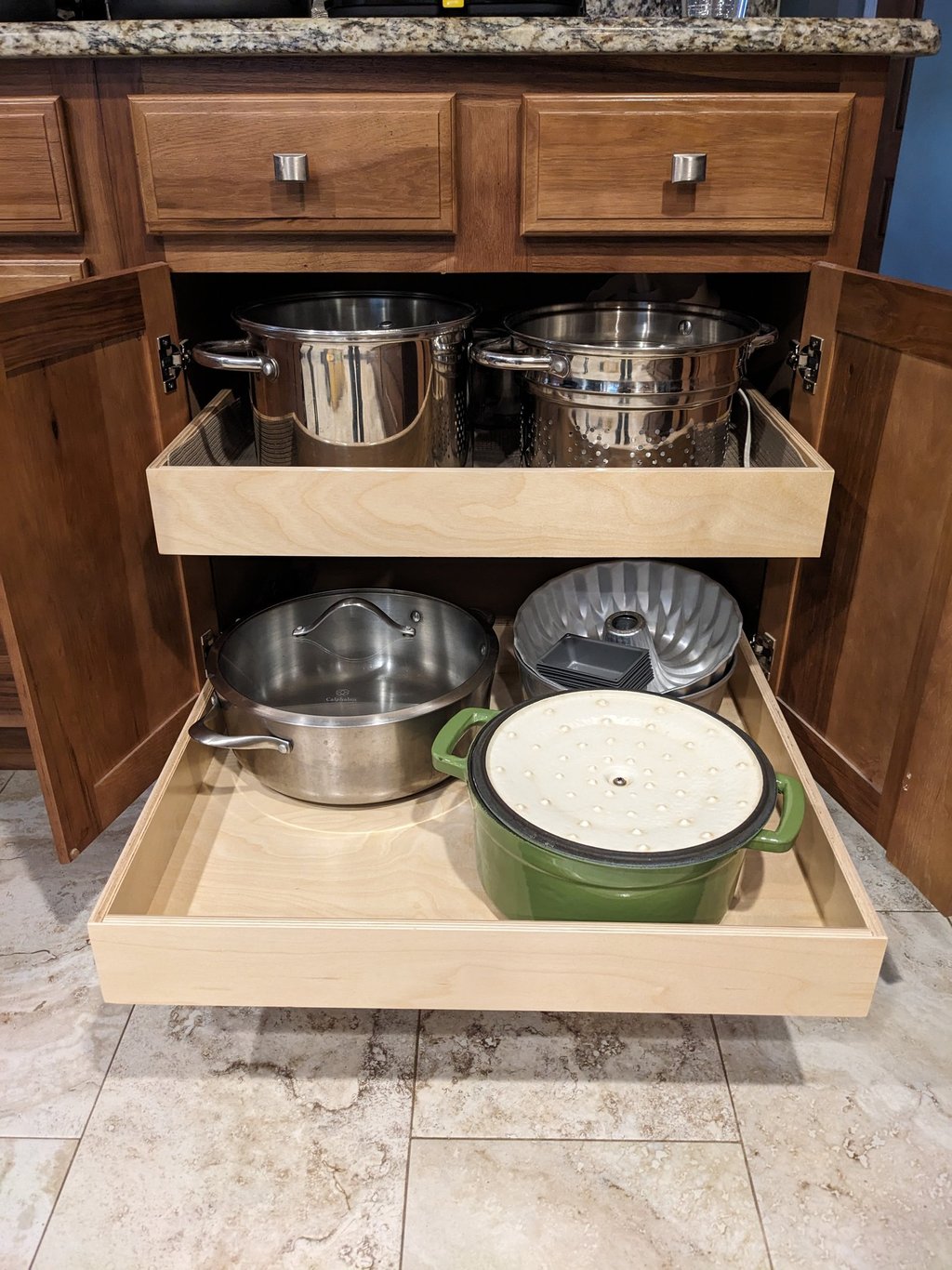 Kitchen cupboard pullouts holding pots and pans.