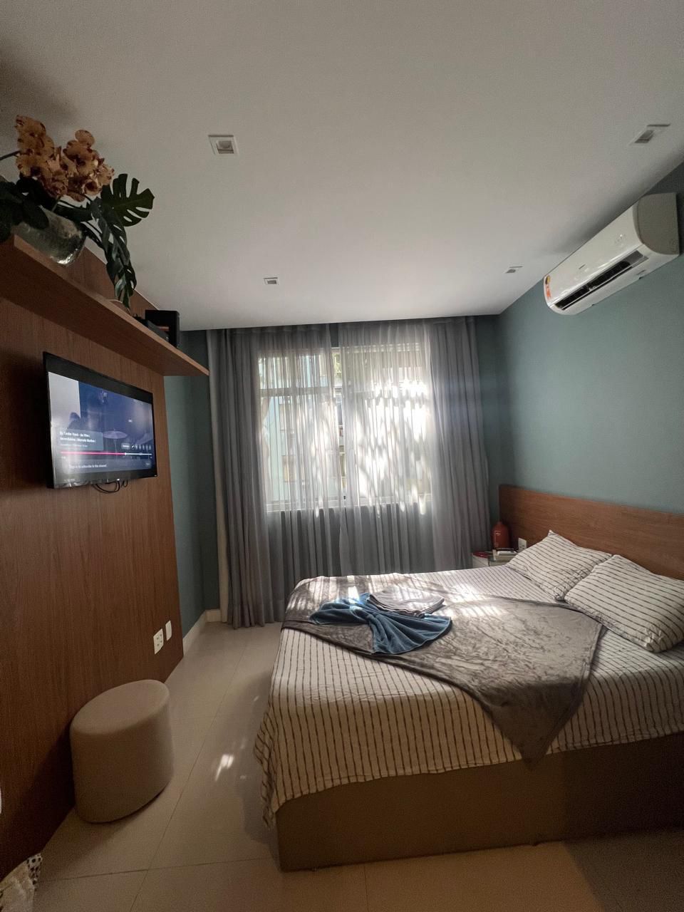 a bedroom with a bed and a television