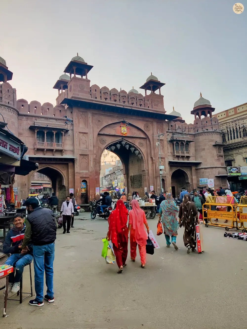 Street view of Kote Gate Bazaar in Bikaner, with traditional shops and bustling local crowds.