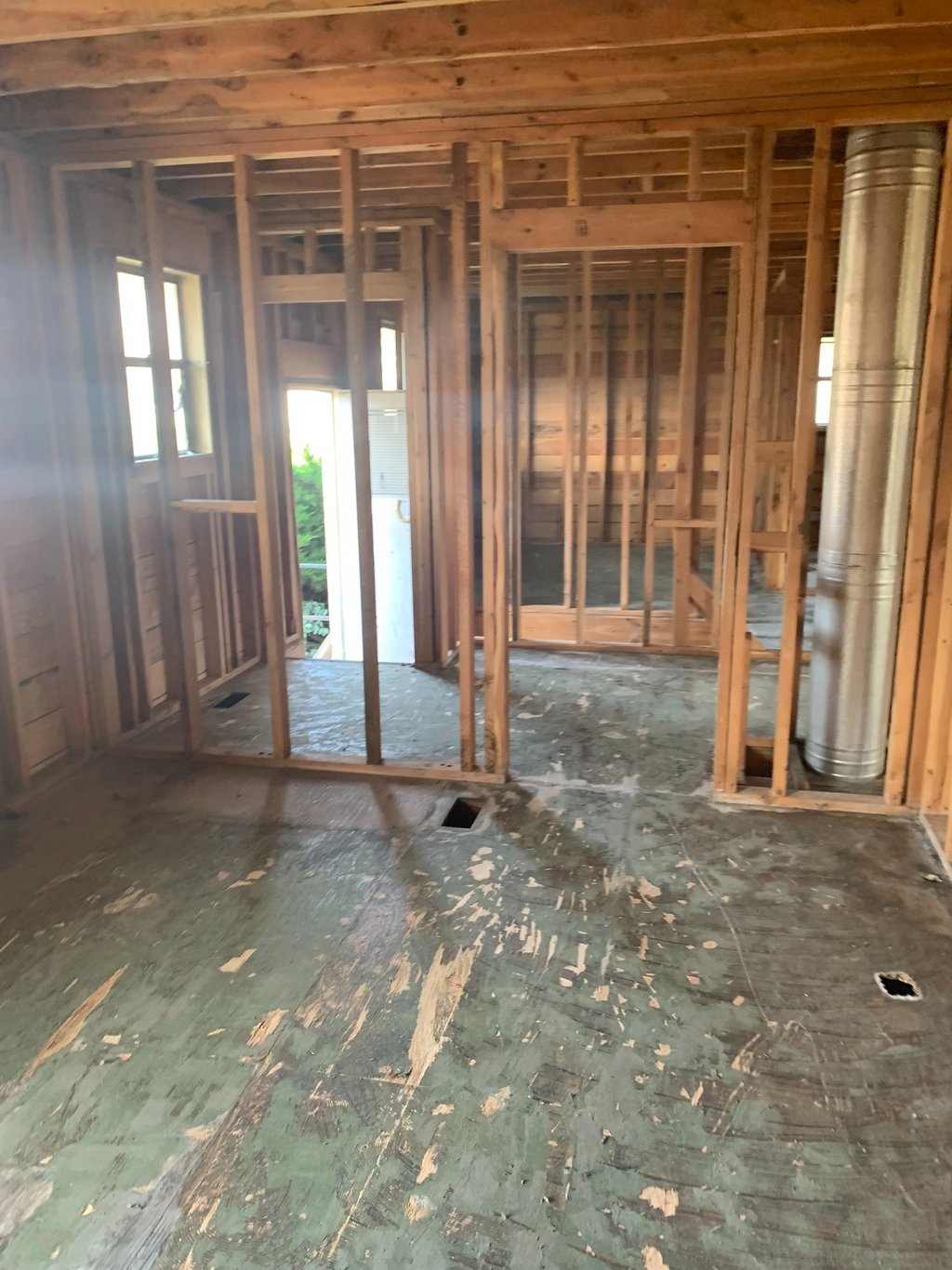 wall framing exposed, flooring removed