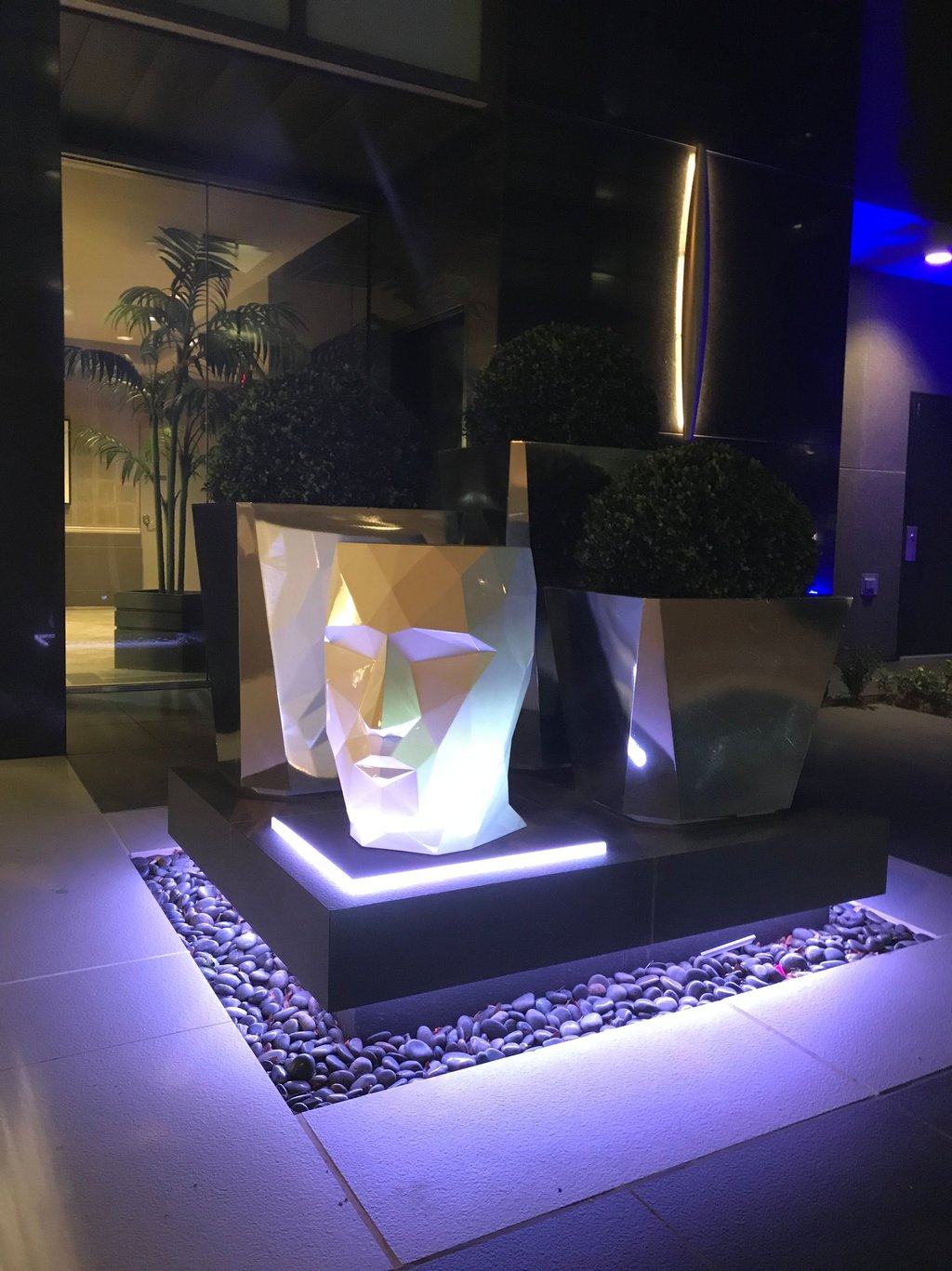 RGB strip lighting installed in hardscape to illuminate walkway and accent feature