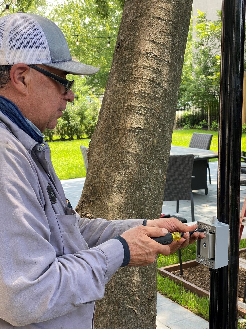 landscape lighting technician installing a dimmer switch
