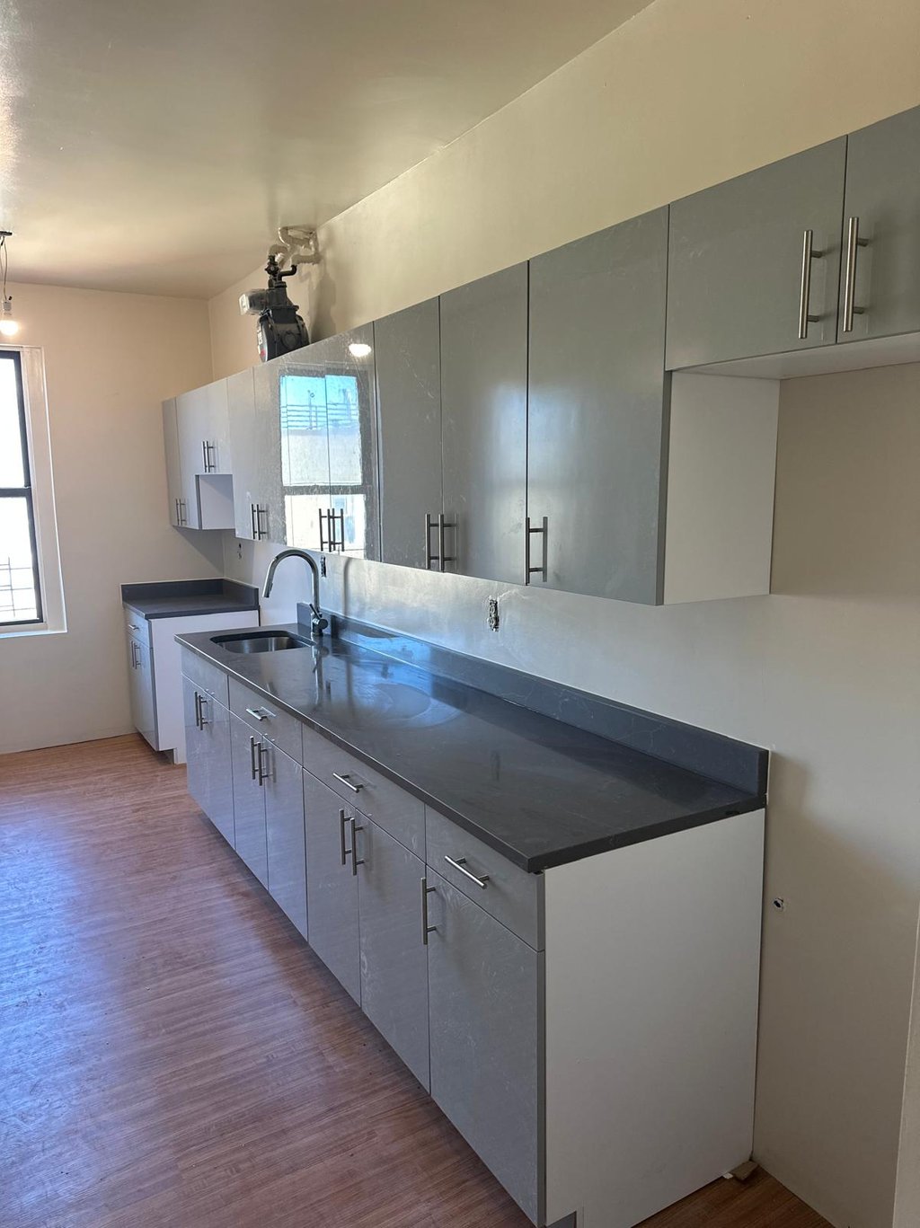a kitchen with a counter top and cabinets