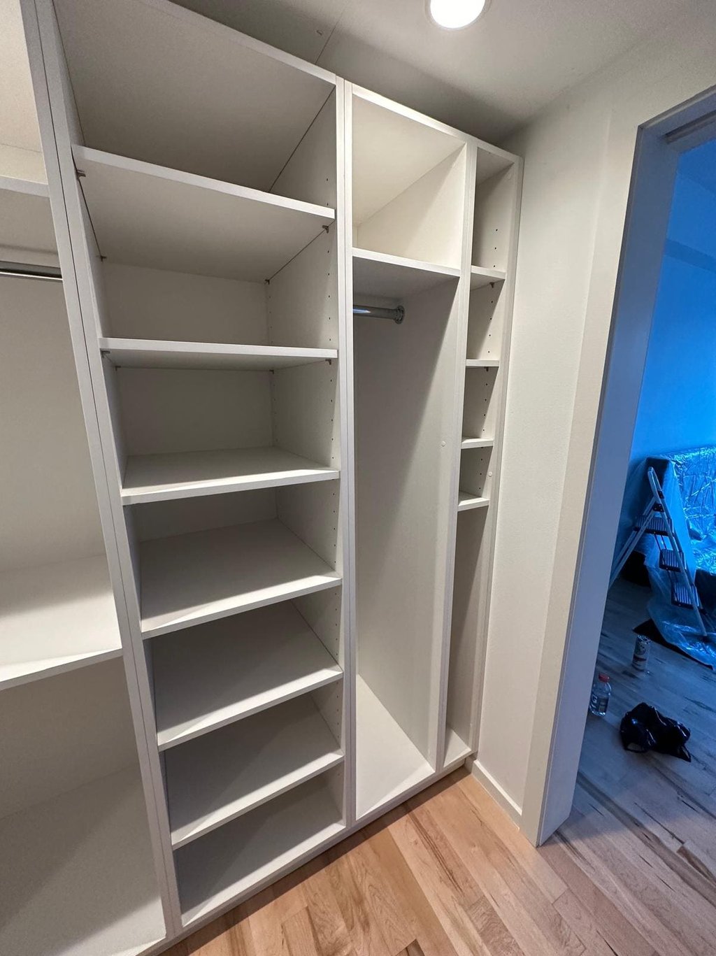 a closet with a closet door open and a closet door open