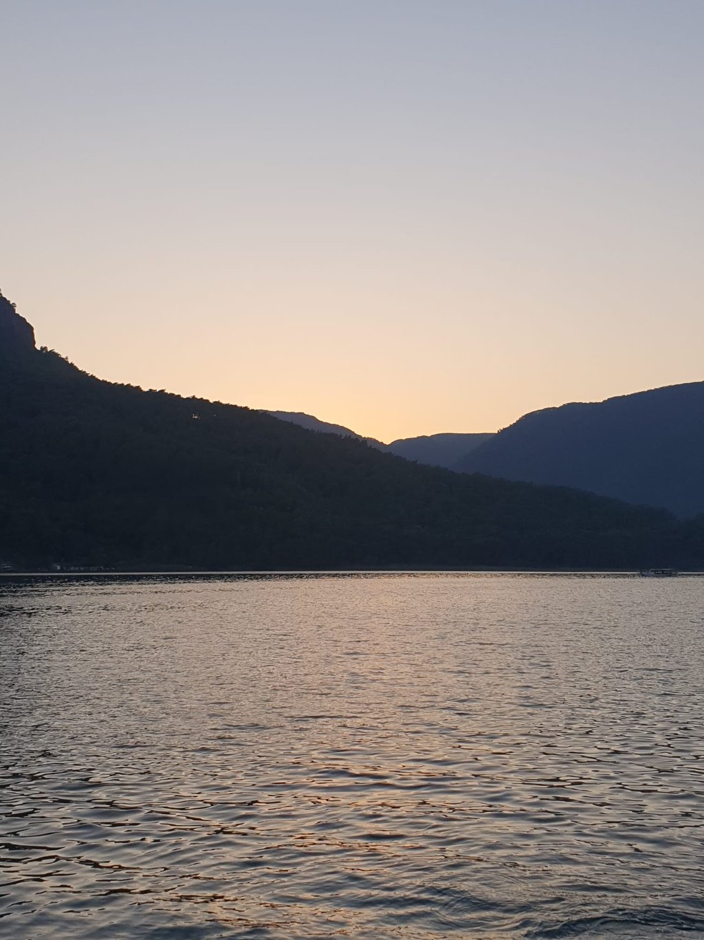 a boat is sailing on the water at sunset