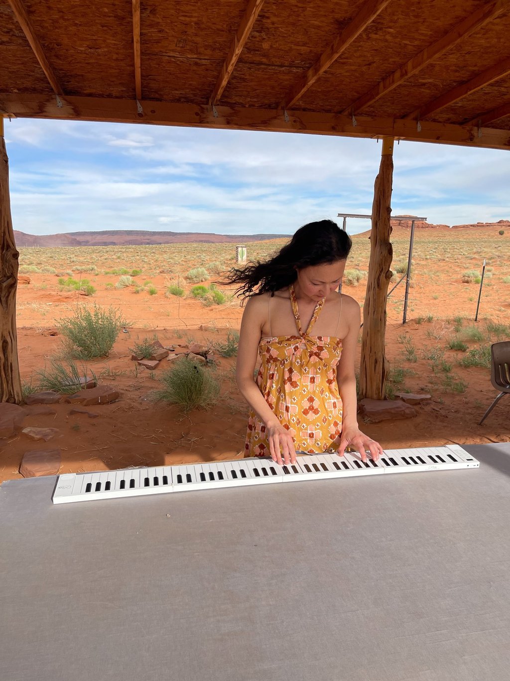 Composer Jen Smith Lanthier in the Arizona desert playing a piano keyboard