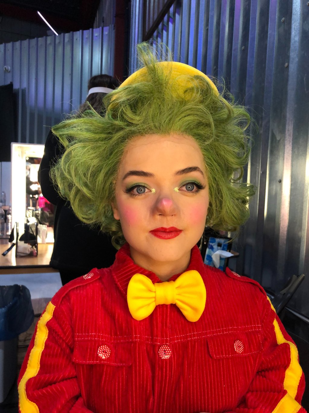 A character from a production displaying theatrical makeup  