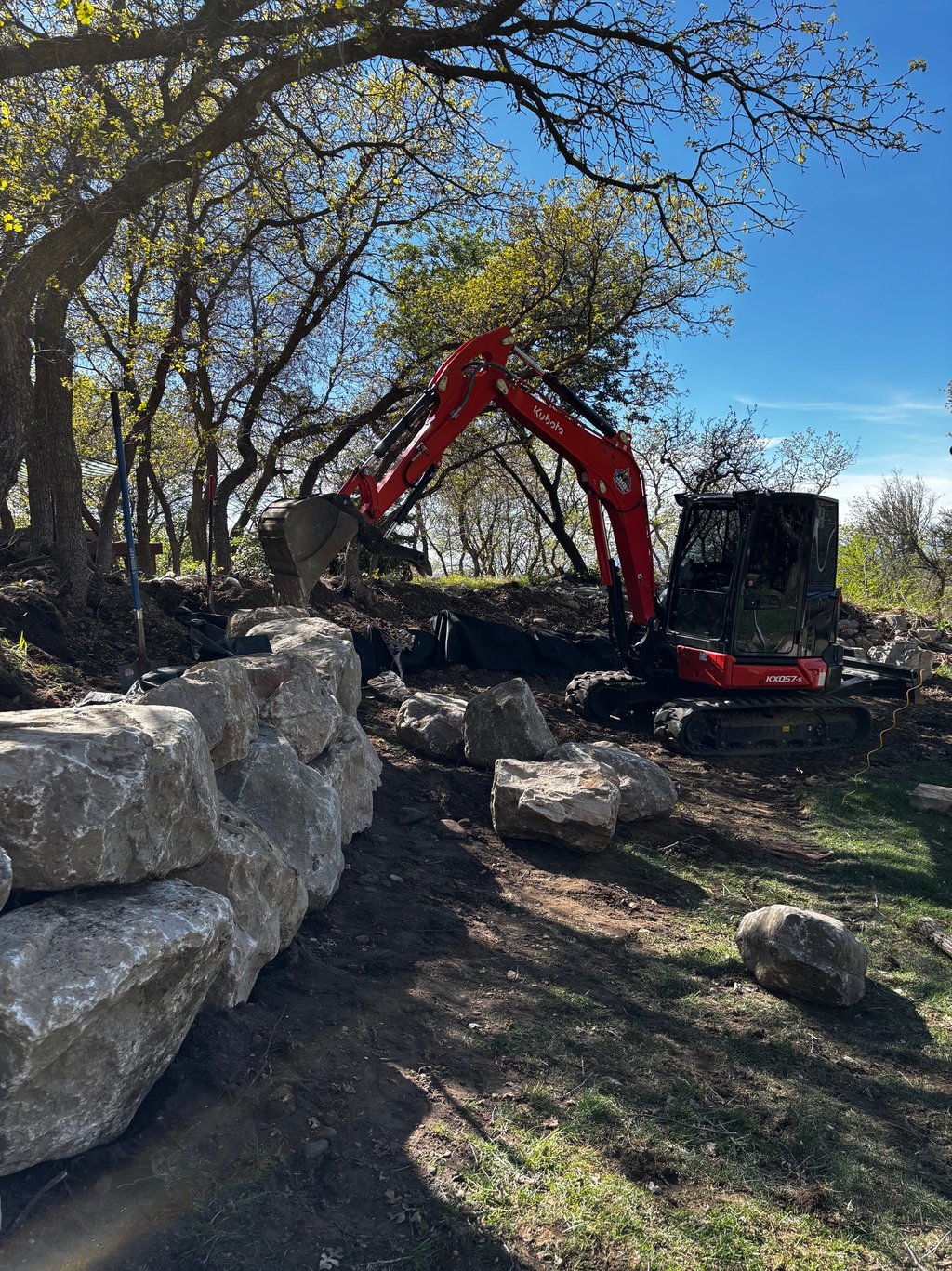 Kubota KX057-s building a boulder wall in northern Utah