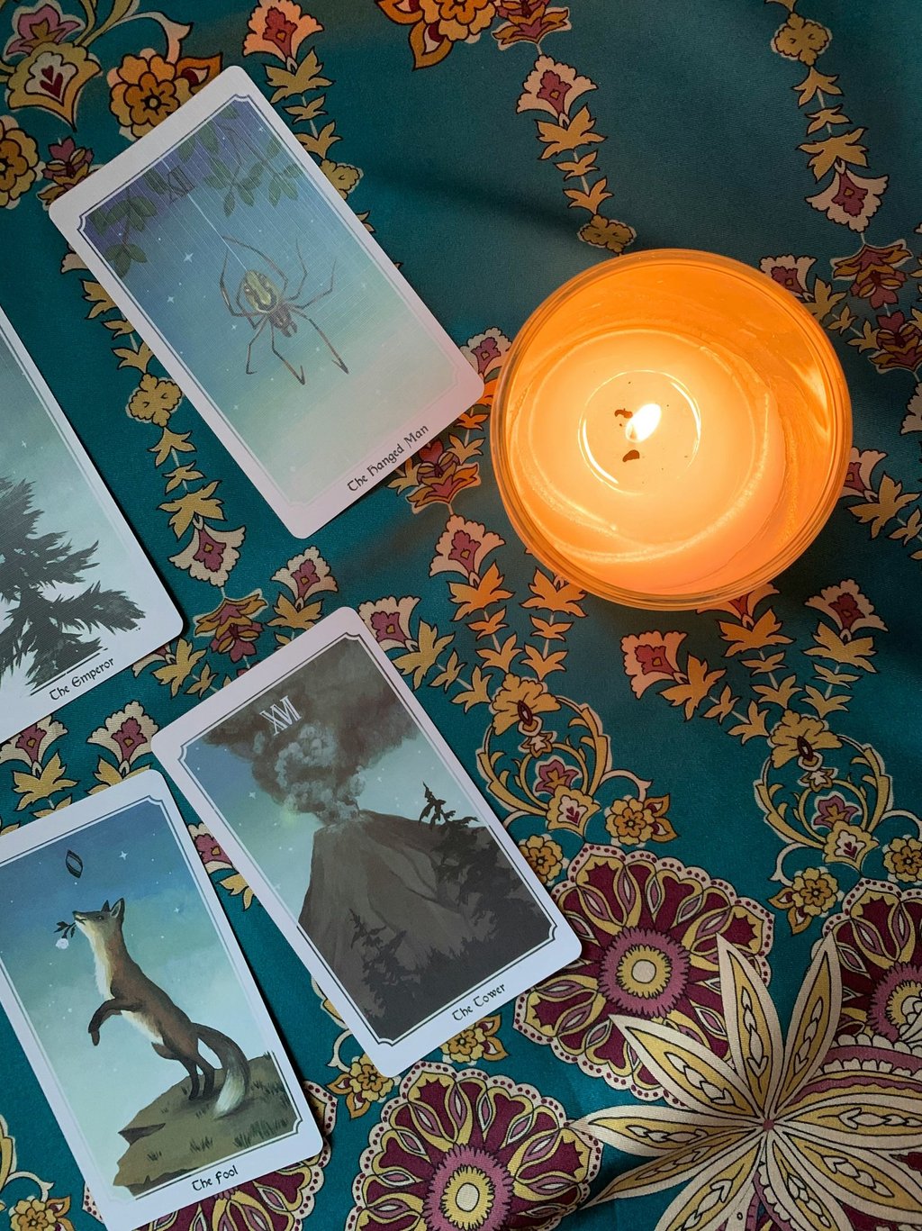 Tarot cards and blue table cloth. Photo by Airis Noyer at Unsplash.