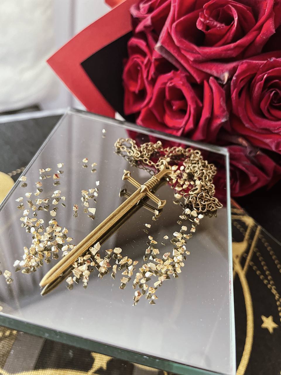 a gold sword accessory on a table