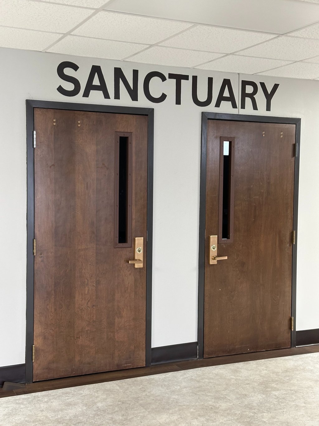 Sign paining of Sanctuary leading to a church sanctuary.