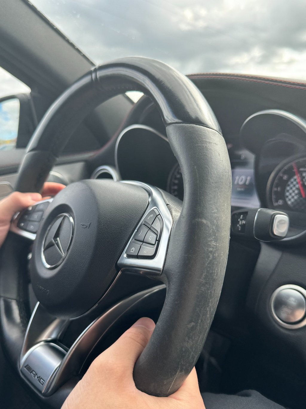 a person holding a steering wheel in a car